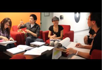 students studying together in a lounge with red couch