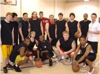 basketball team posing in gym